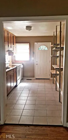 a view of a living room with kitchen