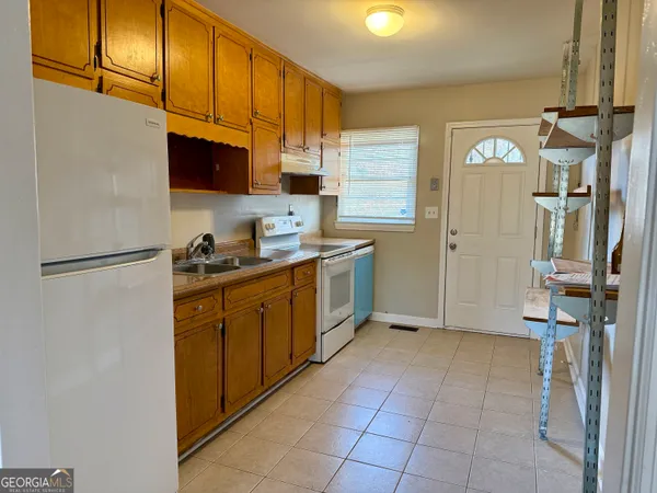 a kitchen with stainless steel appliances granite countertop a refrigerator and a stove