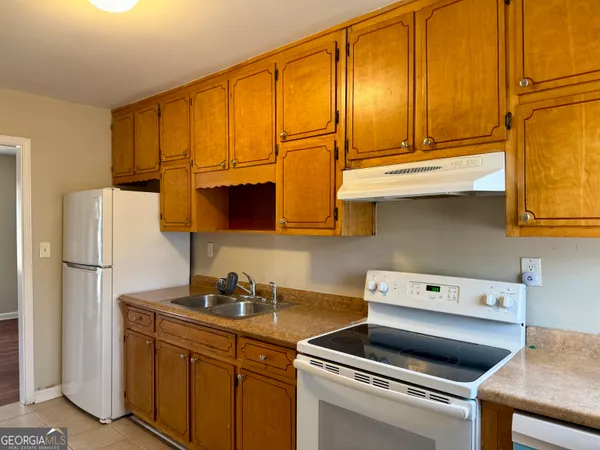 a kitchen with a sink cabinets and appliances