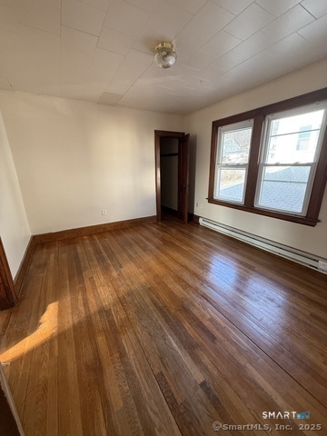 150 Wall Street Waterbury, CT 06705 - Photo 5 of 8 a view of an empty room with wooden floor and a window