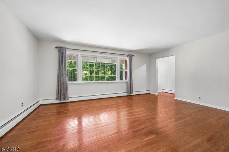 335 Drakestown Road Long Valley, NJ 07853 - Photo 5 of 34 wooden floor in an empty room with a window