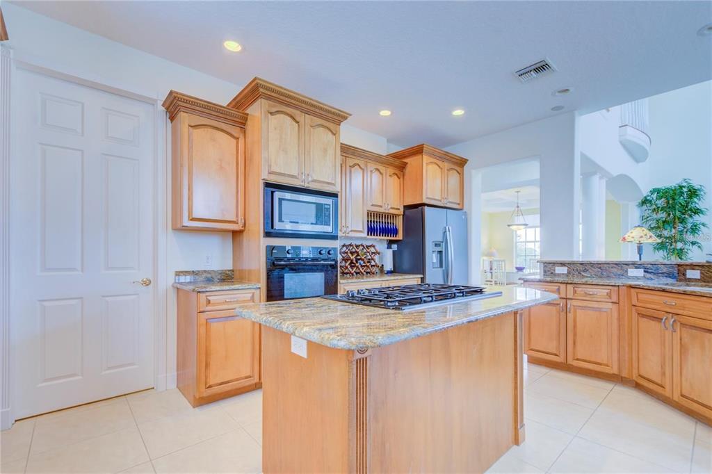 7352 Gulf Way Hudson, FL 34667 - Photo 15 of 69 a kitchen with stainless steel appliances granite countertop a sink stove and refrigerator