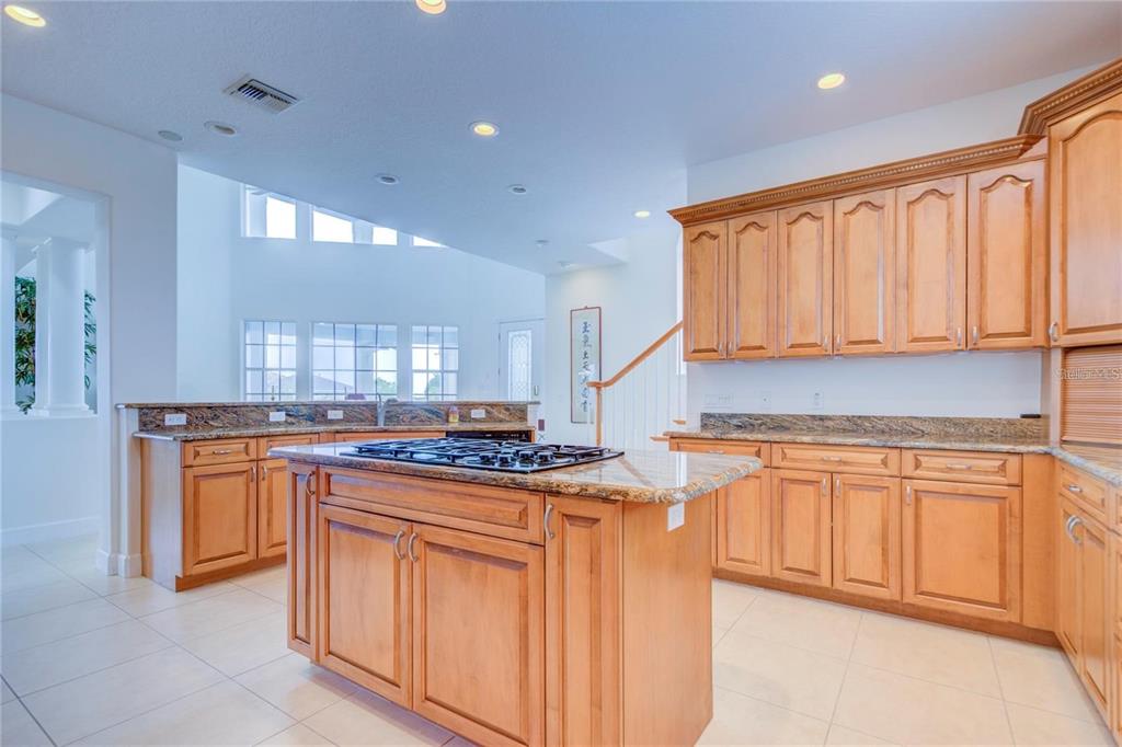 7352 Gulf Way Hudson, FL 34667 - Photo 16 of 69 a kitchen with stainless steel appliances granite countertop a stove a sink and a refrigerator