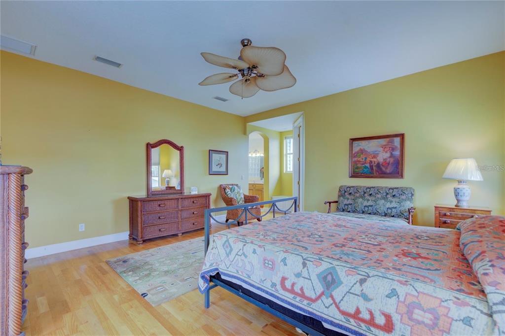 7352 Gulf Way Hudson, FL 34667 - Photo 21 of 69 a bedroom with a bed and a dresser with mirror