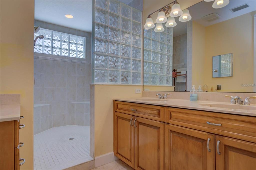 7352 Gulf Way Hudson, FL 34667 - Photo 23 of 69 a bathroom with a sink a large mirror and a shower