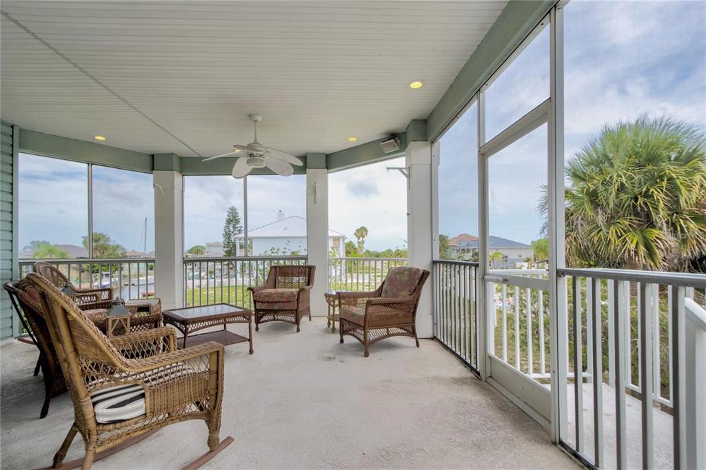 7352 Gulf Way Hudson, FL 34667 - Photo 32 of 69 a balcony with furniture and floor to ceiling window