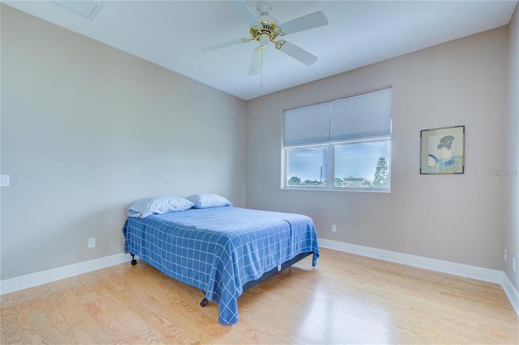 7352 Gulf Way Hudson, FL 34667 - Photo 34 of 69 a bedroom with a bed and a chandelier