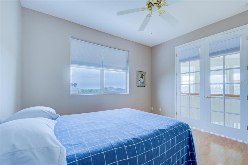 7352 Gulf Way Hudson, FL 34667 - Photo 35 of 69 a bedroom with a bed and a chandelier