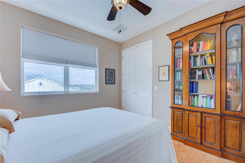 7352 Gulf Way Hudson, FL 34667 - Photo 38 of 69 a bedroom with a bed and a book shelf