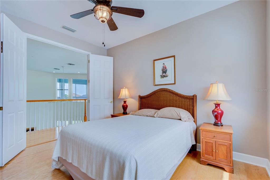 7352 Gulf Way Hudson, FL 34667 - Photo 39 of 69 a bedroom with a bed and a chandelier