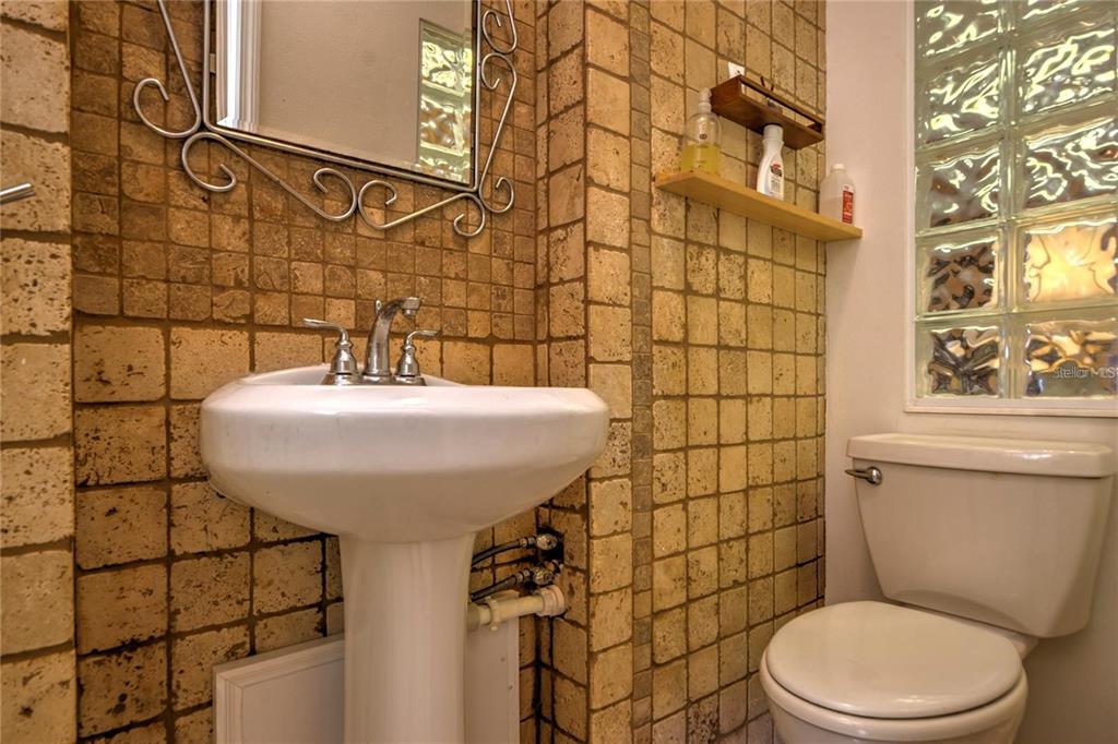 7352 Gulf Way Hudson, FL 34667 - Photo 51 of 69 a bathroom with a sink a toilet and shower curtain
