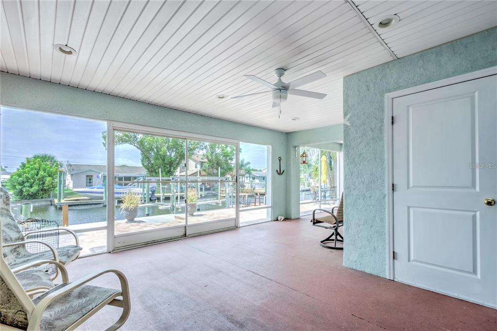 7352 Gulf Way Hudson, FL 34667 - Photo 53 of 69 a living room with furniture and a floor to ceiling window