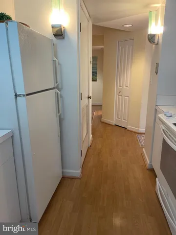 a view of a storage & utility room with refrigerator