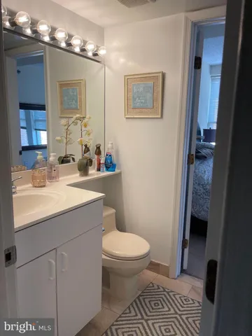 a bathroom with a sink toilet and mirror