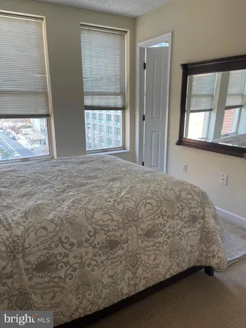 a bed sitting in a bedroom next to a window