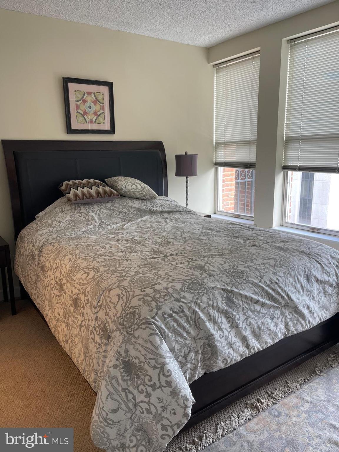 601 Pennsylvania Avenue Northwest, Unit 710 Washington, DC 20004 - Photo 10 of 20 a bedroom with a bed and wooden floor