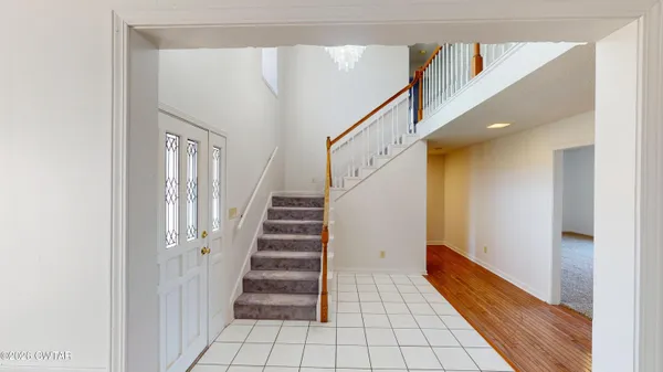 a view of entryway with stairs and wooden floor