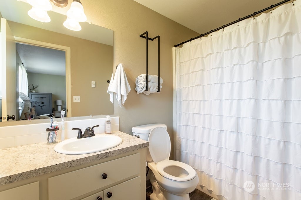 250 Classe Road Toledo, WA 98591 - Photo 12 of 25 a bathroom with a granite countertop sink and a mirror