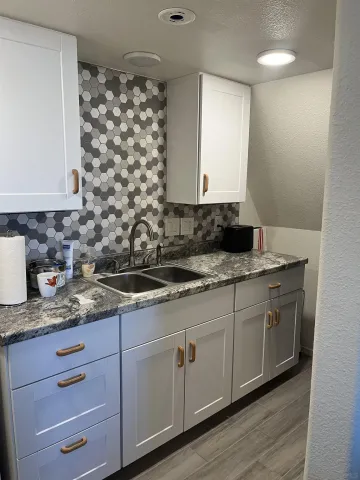 a kitchen with sink and cabinets