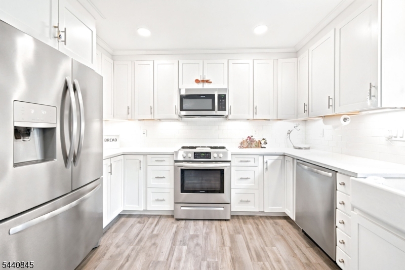 36 Forest Road Andover, NJ 07821 - Photo 29 of 50 a kitchen with granite countertop white cabinets and stainless steel appliances