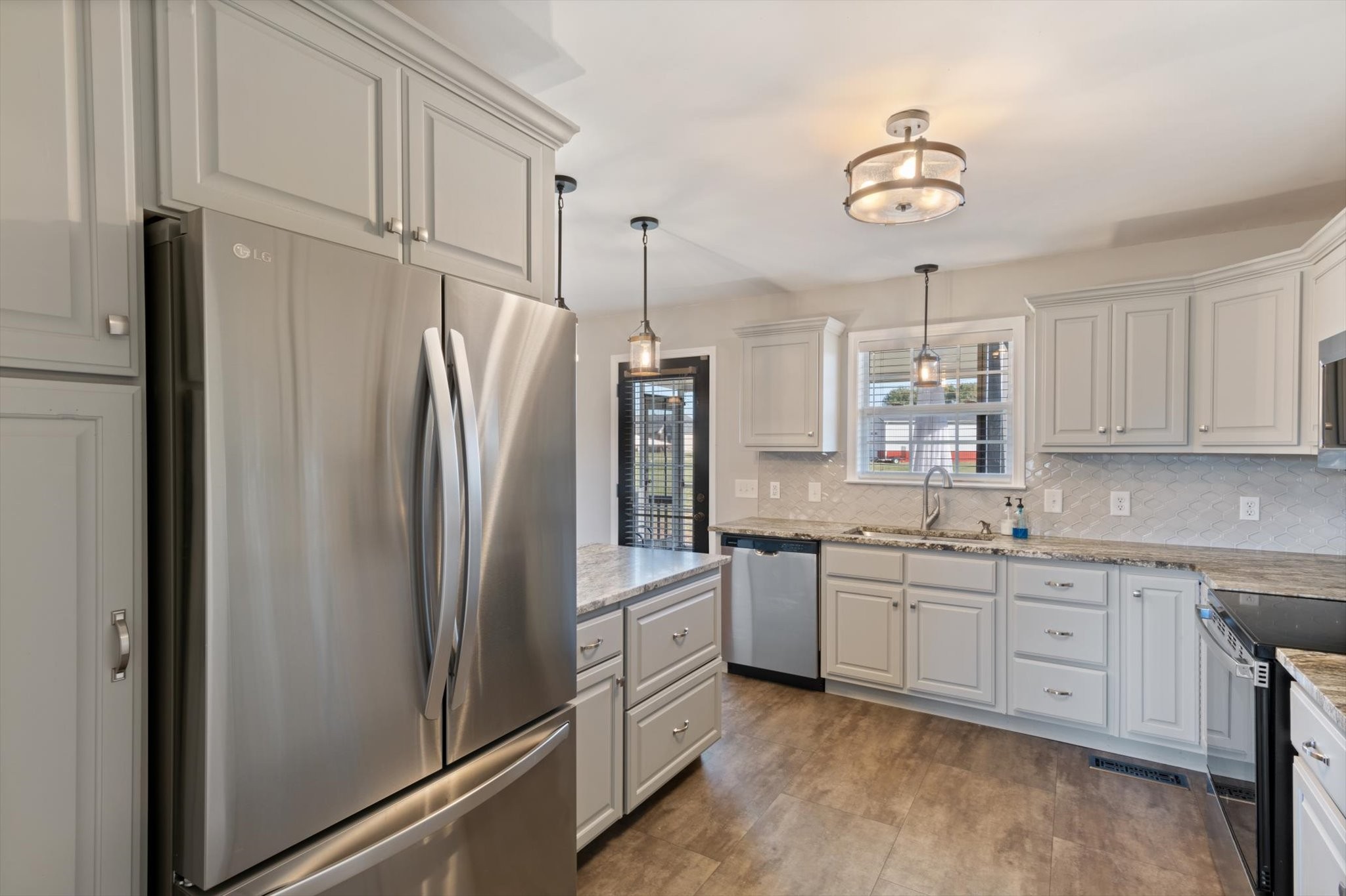 1004 Weiss Road Cottontown, TN 37048 - Photo 8 of 26 a kitchen with stainless steel appliances a refrigerator sink and cabinets