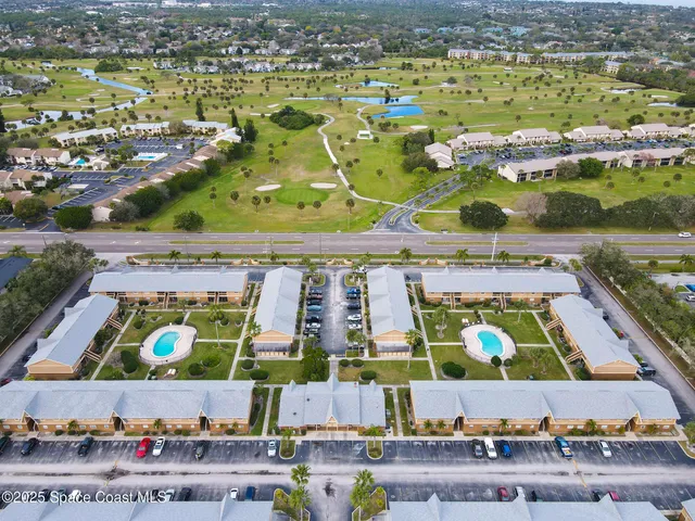 an aerial view of a house with a swimming pool