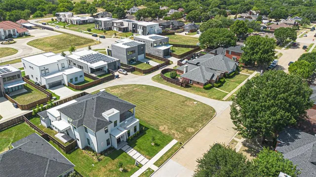 an aerial view of residential houses with outdoor space