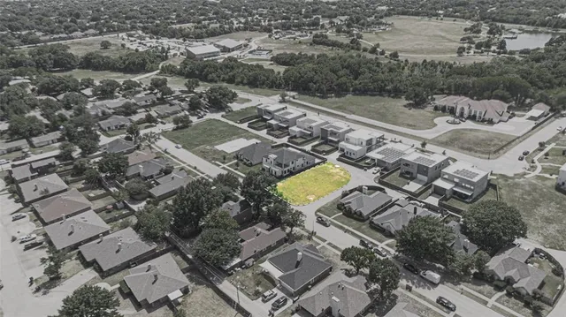 an aerial view of a residential houses with outdoor space