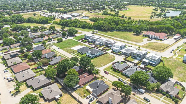 an aerial view of residential houses with outdoor space