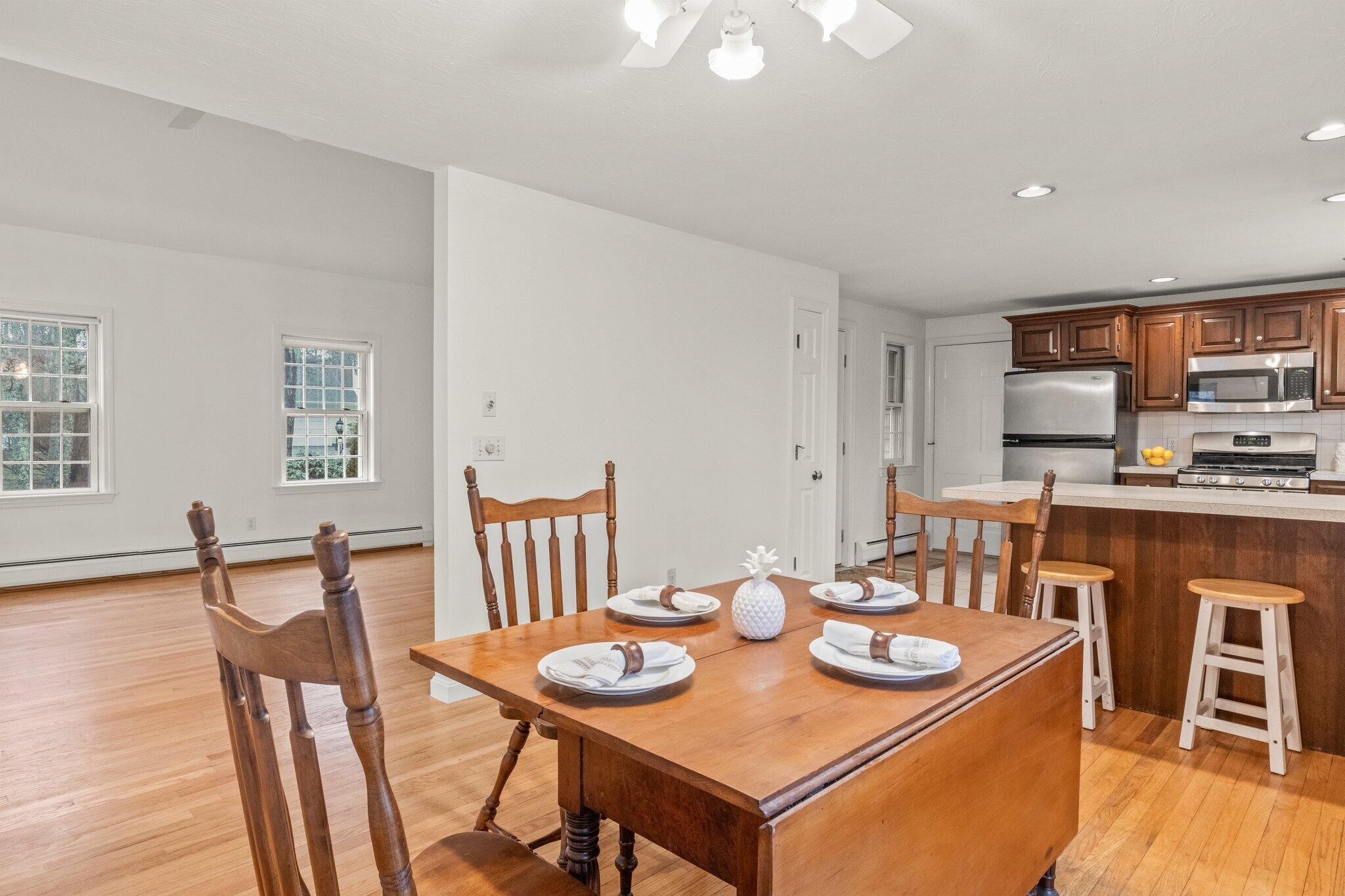 52 Goose Point Road Centerville, MA 02601 - Photo 18 of 71 a view of a dining room with furniture and wooden floor