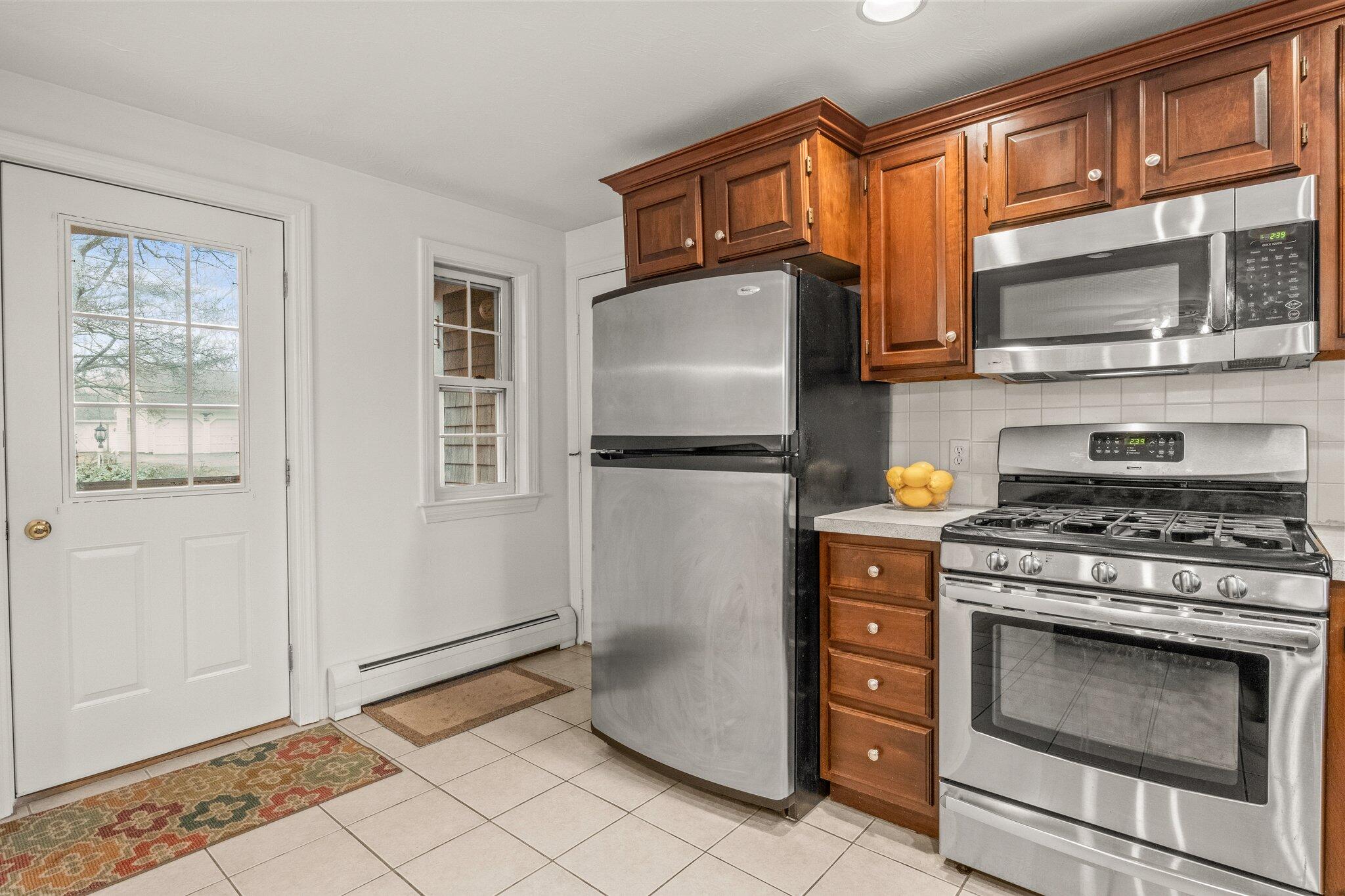 52 Goose Point Road Centerville, MA 02601 - Photo 20 of 71 a kitchen with stainless steel appliances granite countertop a refrigerator stove and microwave