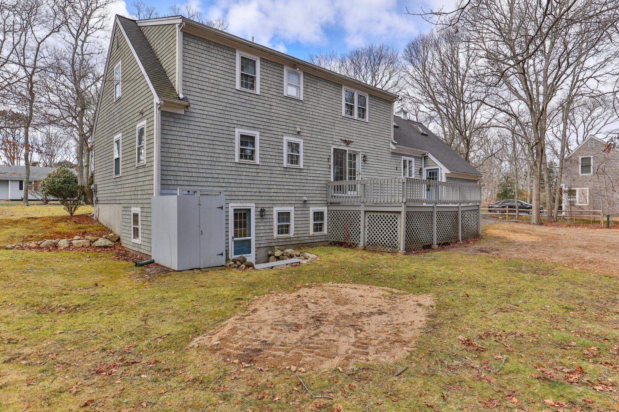 52 Goose Point Road Centerville, MA 02601 - Photo 2 of 71 a view of a house with a yard and garage