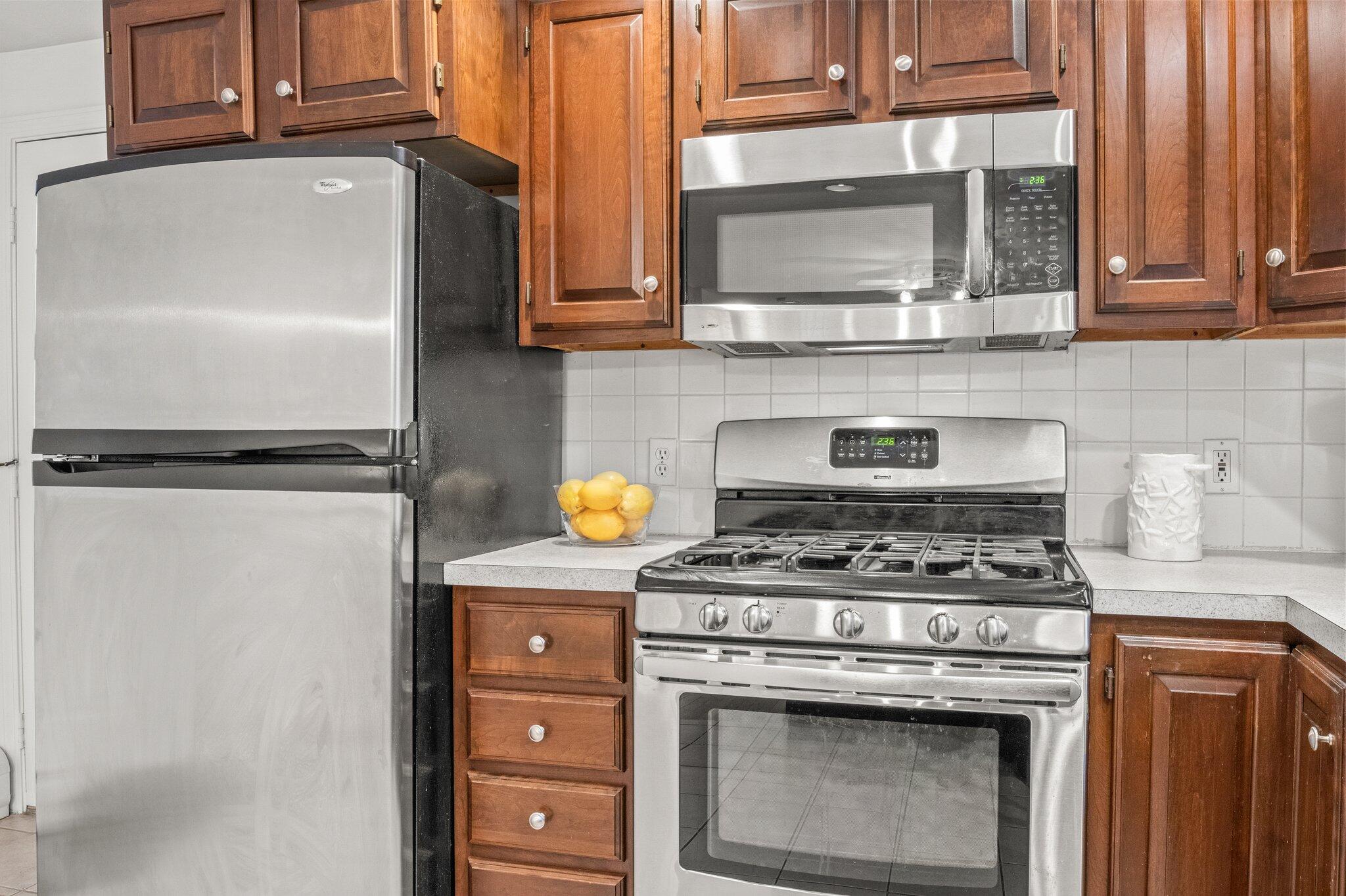 52 Goose Point Road Centerville, MA 02601 - Photo 21 of 71 a kitchen with stainless steel appliances granite countertop a stove and a microwave