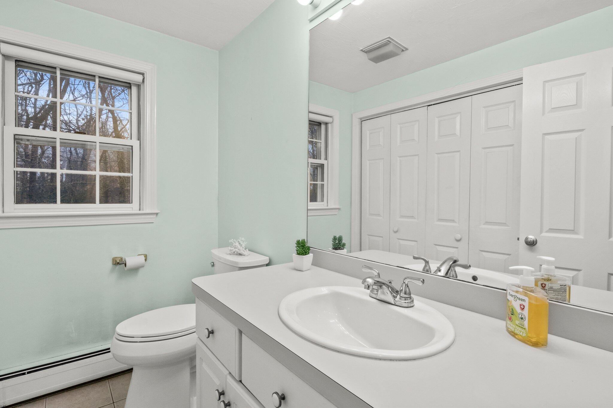 52 Goose Point Road Centerville, MA 02601 - Photo 25 of 71 a bathroom with a sink a toilet and a mirror