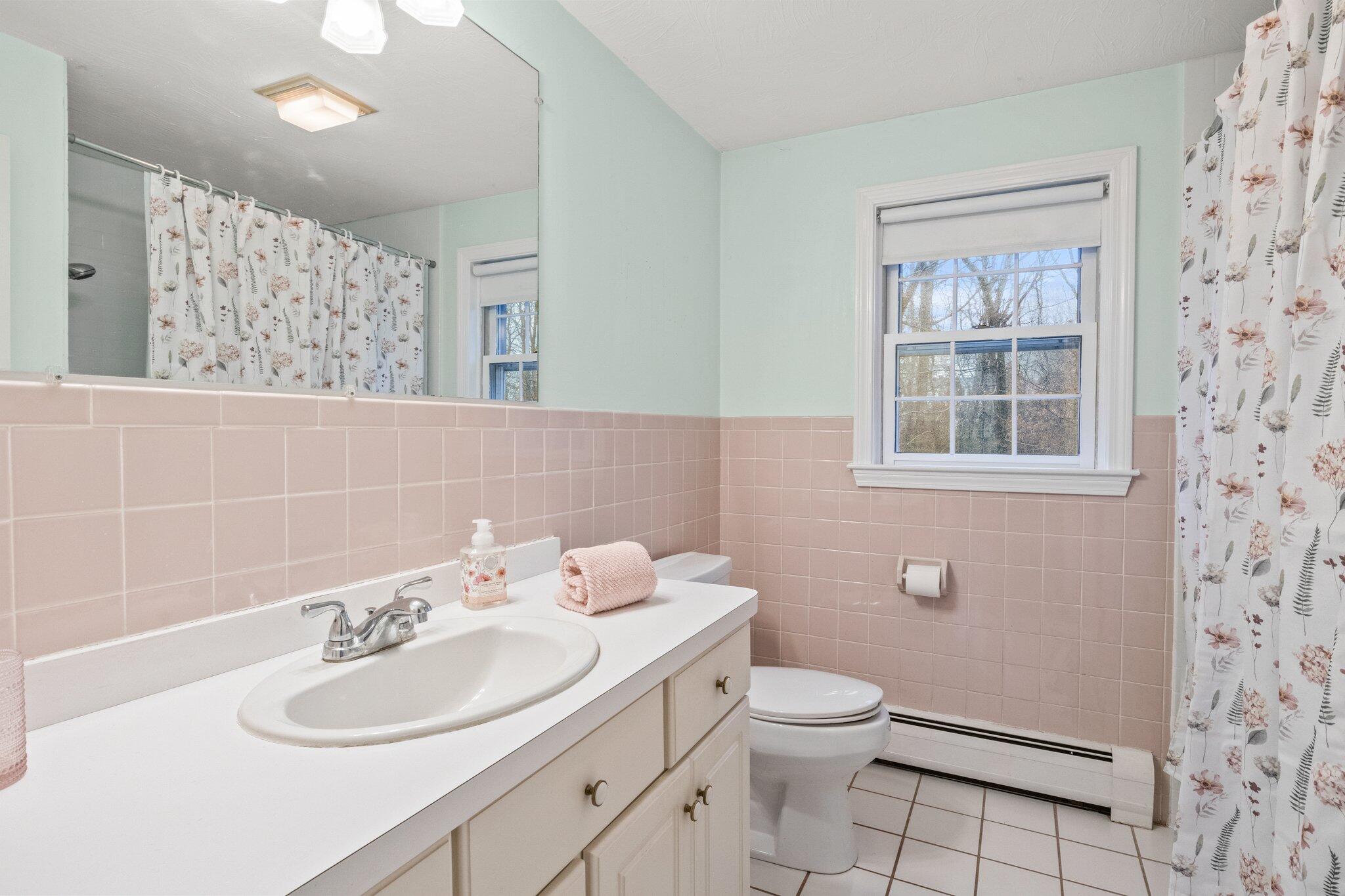 52 Goose Point Road Centerville, MA 02601 - Photo 30 of 71 a bathroom with a sink toilet and a mirror