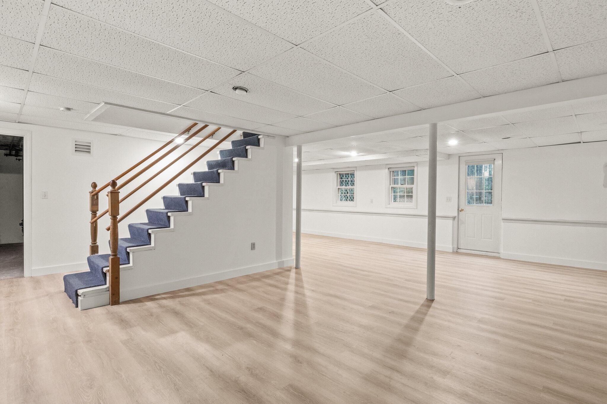 52 Goose Point Road Centerville, MA 02601 - Photo 47 of 71 a view of an empty room with wooden floor and stairs