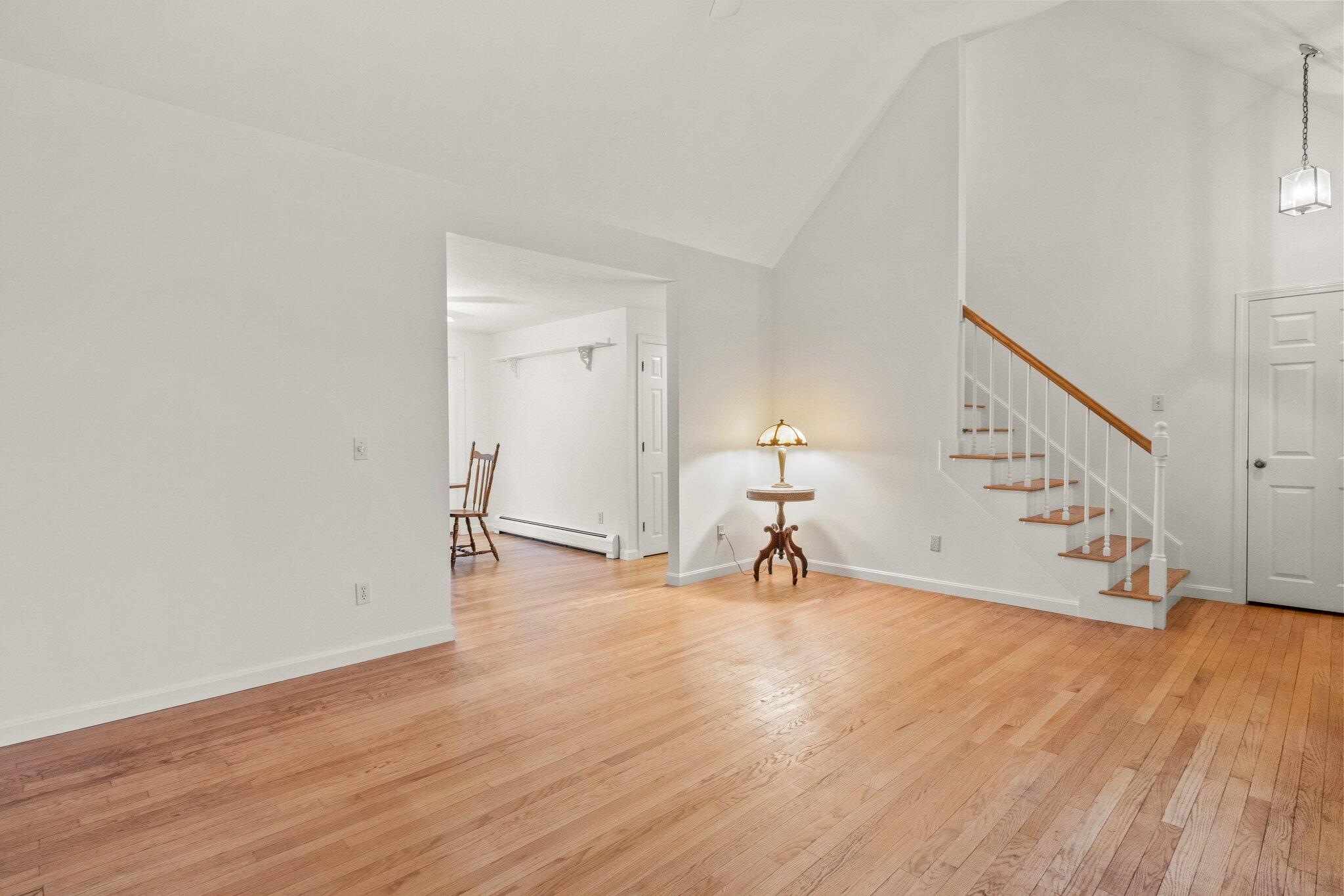 52 Goose Point Road Centerville, MA 02601 - Photo 8 of 71 a view of an empty room with wooden floor and stairs