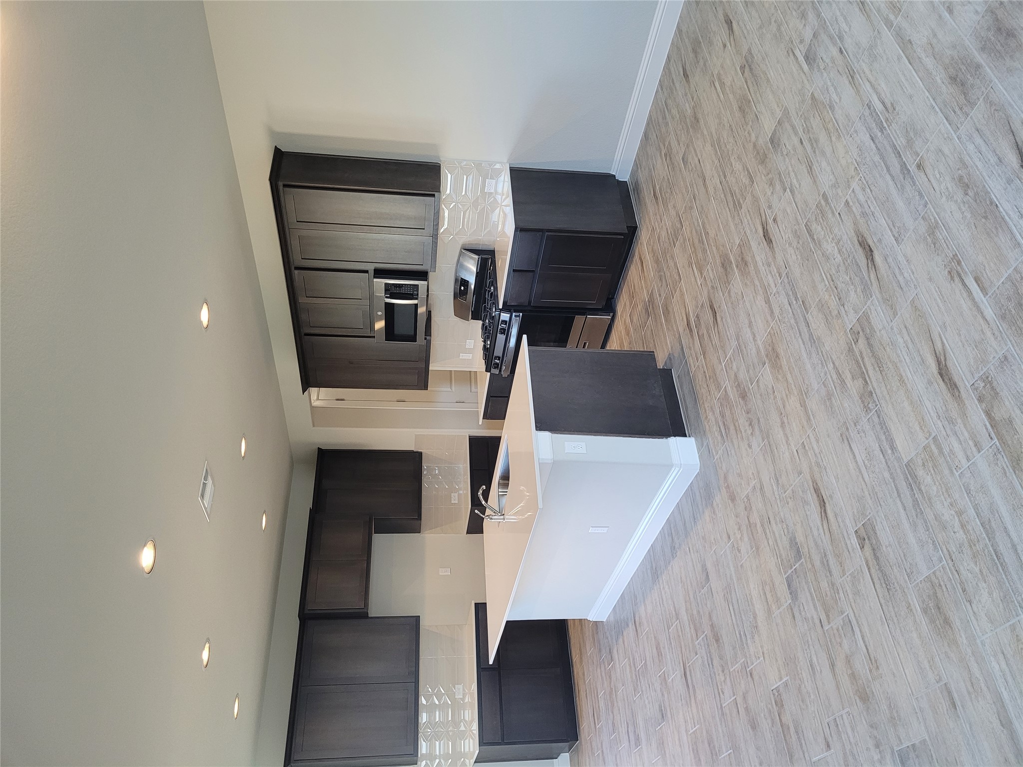 120 Free Stone Drive Georgetown, TX 78628 - Photo 1 of 40 An inviting open-plan kitchen with rich cabinetry and an island centerpiece.