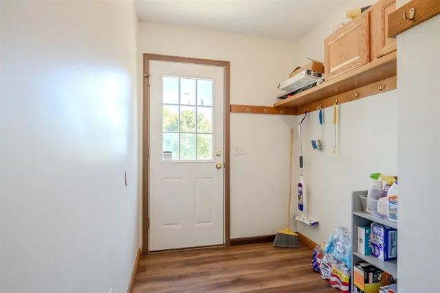 a view of an entryway with wooden floor