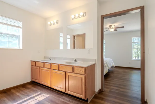 a view of a bathroom with dual sinks