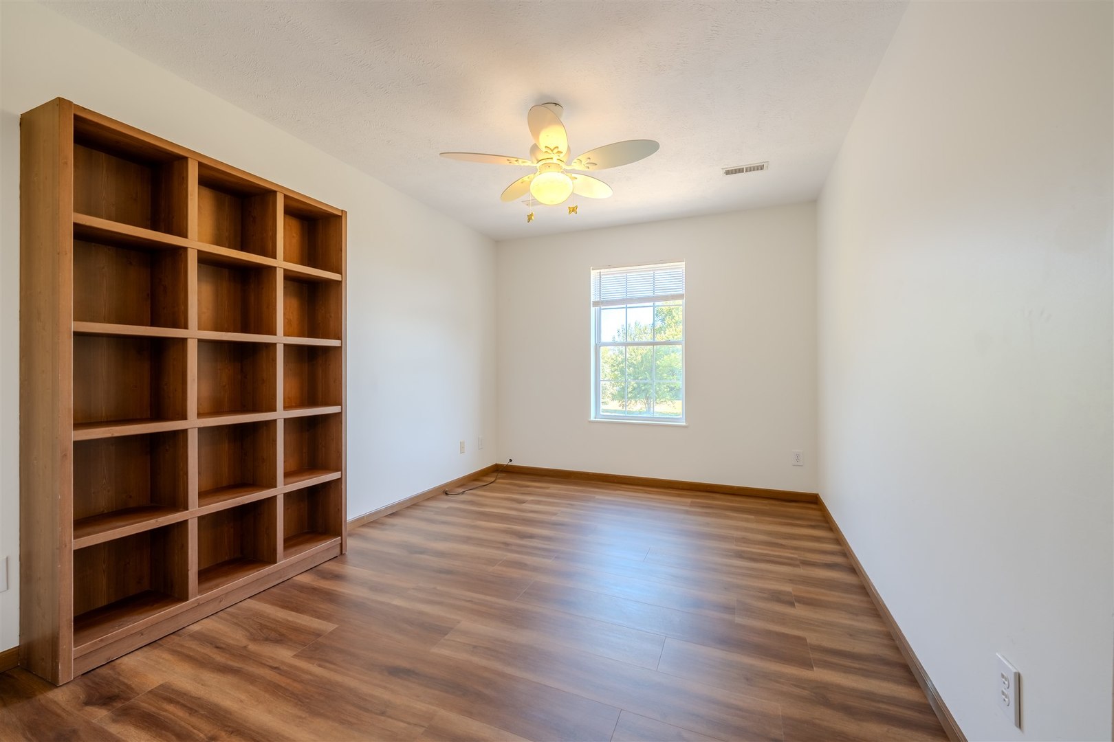 4397 North 3200 East Road Arrowsmith, IL 61722 - Photo 22 of 33 a view of an empty room with a window and wooden floor
