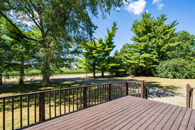 a view of balcony with wooden floor and fence