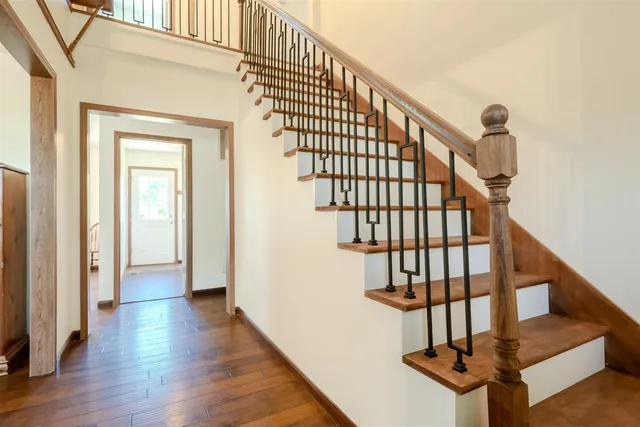 a view of entryway and hall with wooden floor