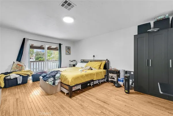 a spacious bedroom with a bed and a window