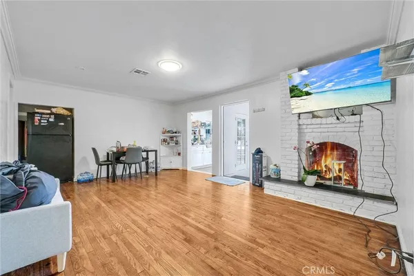 a dining room with furniture and wooden floor