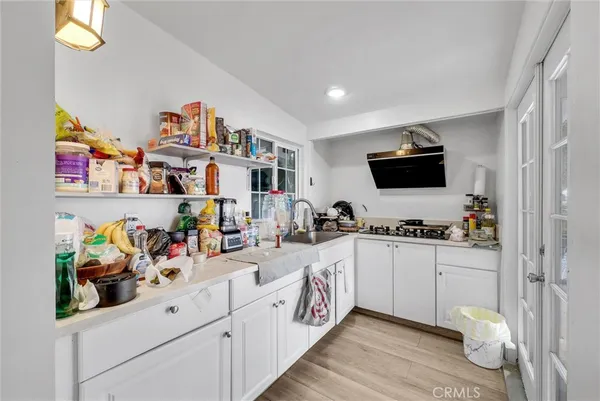 a kitchen filled with a white stove top oven and a table