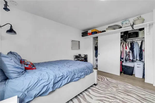 a bedroom with a bed and a walk in closet