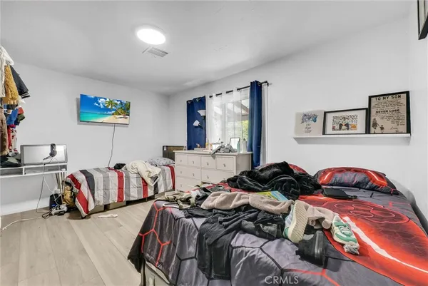 a bedroom with two beds and a walk in closet