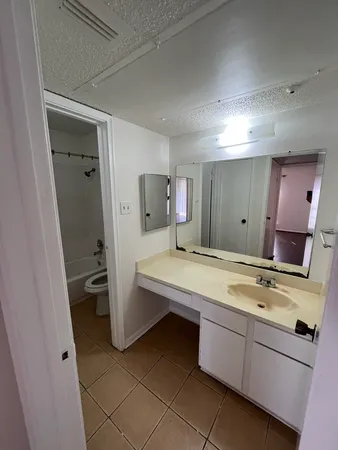 a bathroom with a toilet and a bath tub