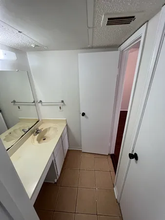 a view of a storage and utility room with wooden floor